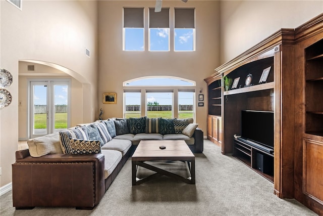 6001 King Trl, Corpus Christi, TX 78414 - carpeted living area with healthy amount of natural light, a high ceiling, and arched walkways