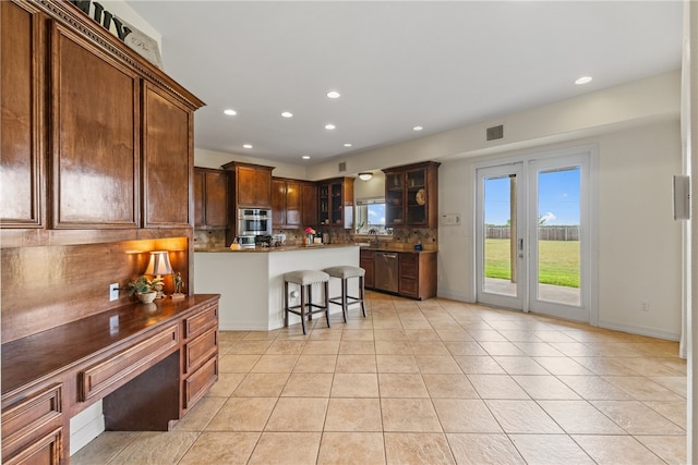 6001 King Trl, Corpus Christi, TX 78414 - kitchen with backsplash, light tile patterned floors, stainless steel dishwasher, glass insert cabinets, and recessed lighting