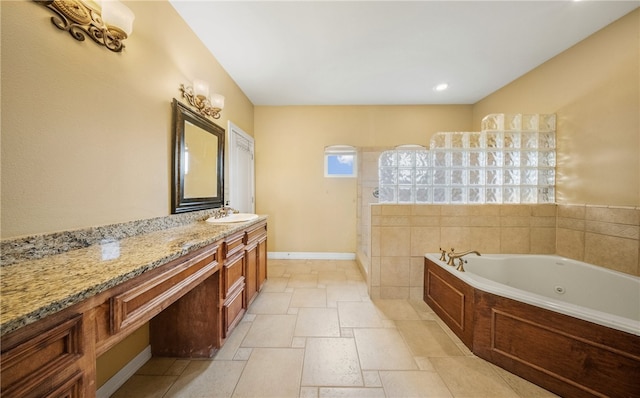 6001 King Trl, Corpus Christi, TX 78414 - bathroom featuring a whirlpool tub, vanity, and stone tile floors