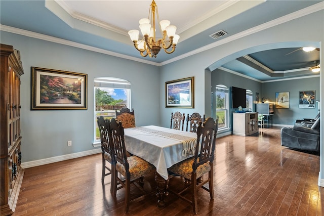 6001 King Trl, Corpus Christi, TX 78414 - dining room featuring a raised ceiling, plenty of natural light, arched walkways, hardwood / wood-style flooring, and crown molding