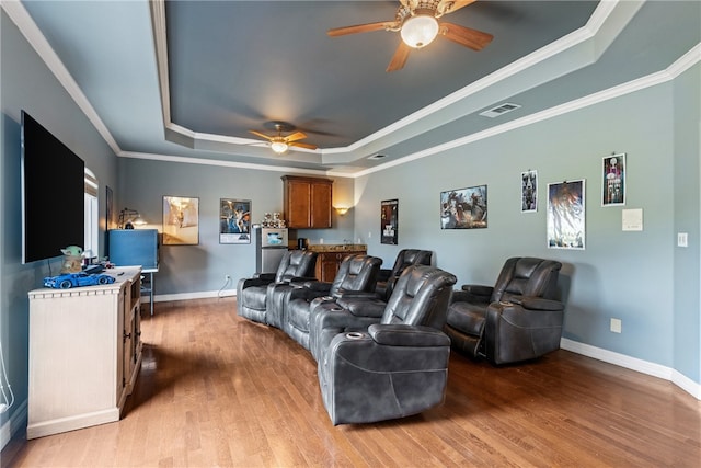 6001 King Trl, Corpus Christi, TX 78414 - home theater room with a raised ceiling, a ceiling fan, light wood-style floors, and ornamental molding