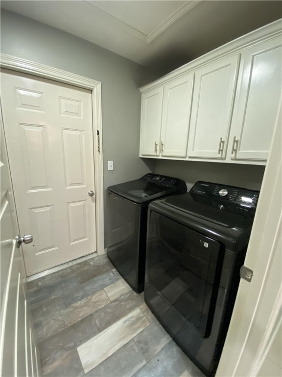 washroom with cabinets and washer and dryer