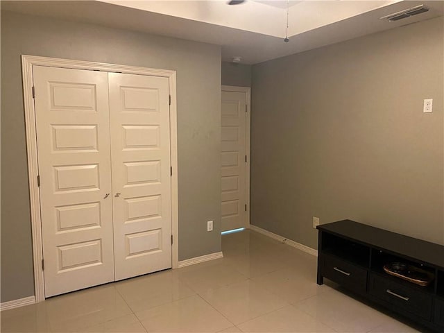 tiled bedroom featuring a closet