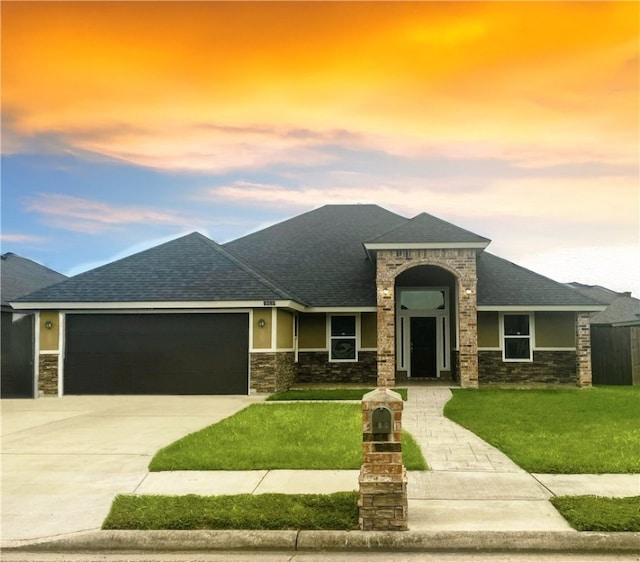 view of front of property with a lawn and a garage