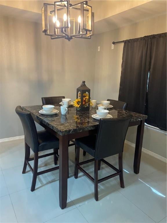 dining area featuring light tile patterned flooring and a chandelier