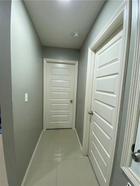 corridor with light tile patterned flooring