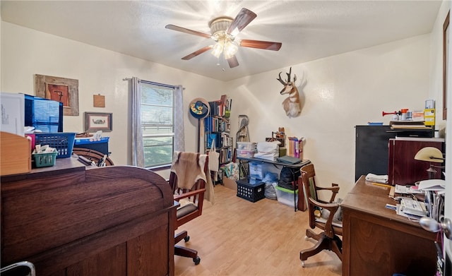 office area with light wood-style flooring and ceiling fan