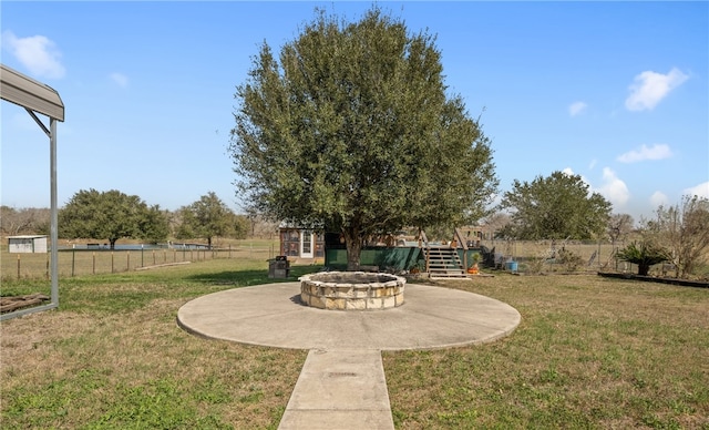 view of yard with a fire pit and fence