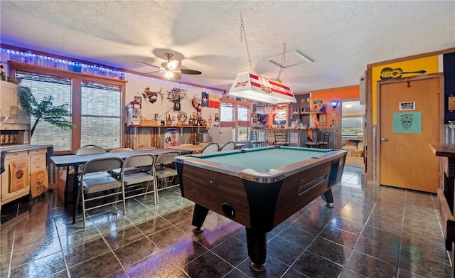 game room with billiards, a dry bar, a ceiling fan, and a textured ceiling