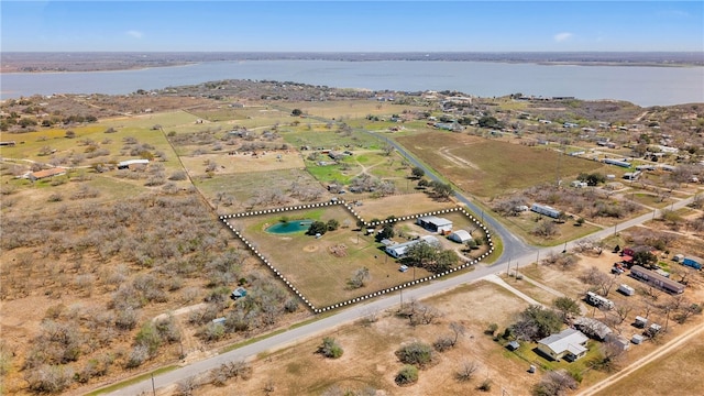 birds eye view of property with a rural view and a water view