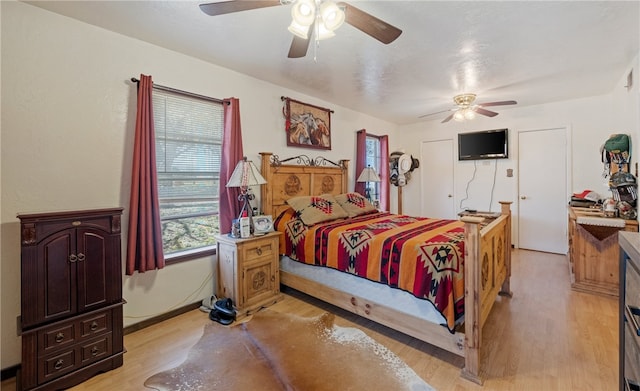 bedroom with ceiling fan and light wood-style flooring