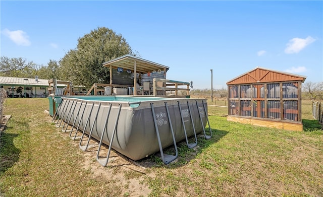 outdoor pool featuring an outdoor structure and a yard