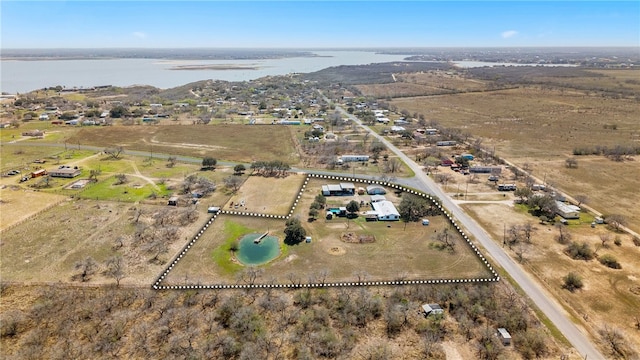 drone / aerial view featuring a water view and a rural view