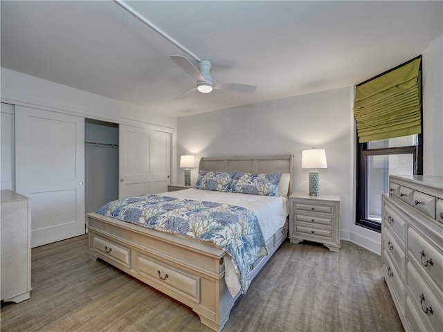 bedroom featuring ceiling fan, a closet, and light hardwood / wood-style flooring