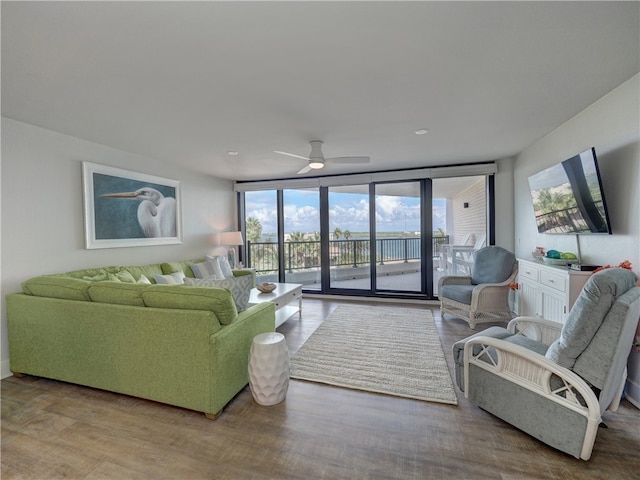 living room with expansive windows, light hardwood / wood-style floors, ceiling fan, and plenty of natural light