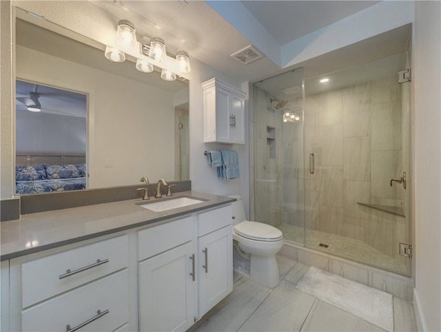 bathroom with walk in shower, vanity, and toilet