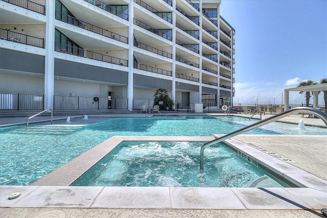 view of swimming pool featuring a community hot tub