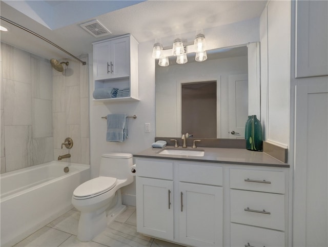 full bathroom featuring a textured ceiling, vanity, tile patterned floors, toilet, and tiled shower / bath combo