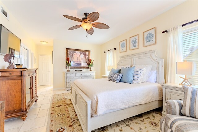 bedroom with multiple windows and ceiling fan