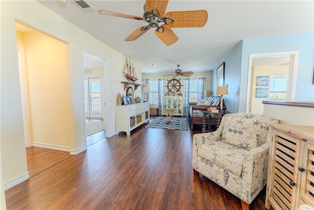 sitting room with a wealth of natural light, dark wood-type flooring, and ceiling fan