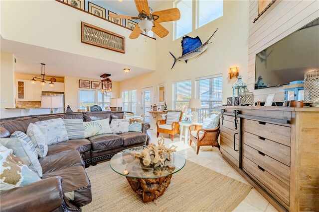 tiled living room featuring a towering ceiling and ceiling fan