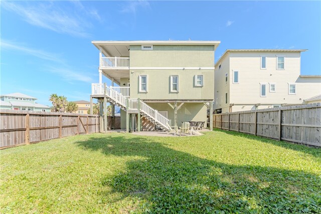 rear view of property featuring a patio area and a yard