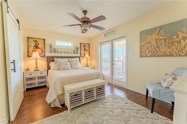 bedroom with access to outside, a barn door, hardwood / wood-style flooring, and ceiling fan