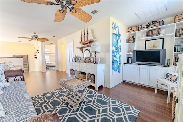 living room with ceiling fan and dark hardwood / wood-style flooring