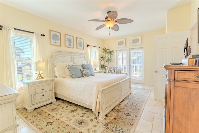 bedroom with multiple windows, ceiling fan, and access to exterior