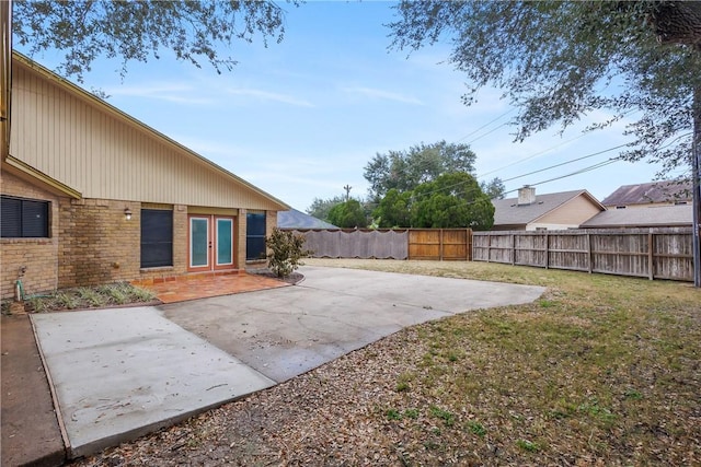 view of yard with french doors and a patio area