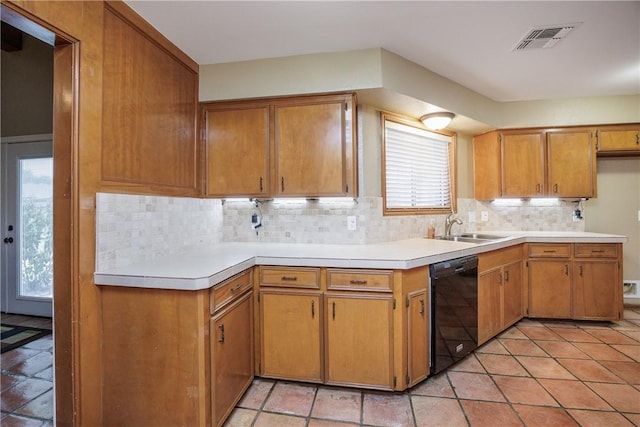 kitchen featuring dishwasher, sink, light tile patterned flooring, and backsplash