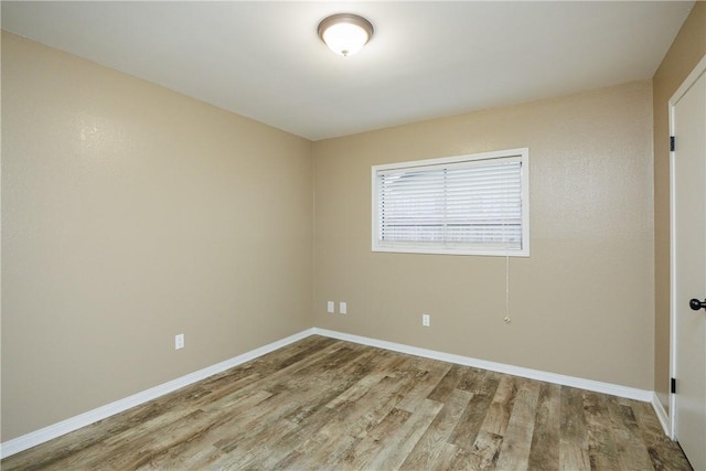 unfurnished room featuring hardwood / wood-style flooring