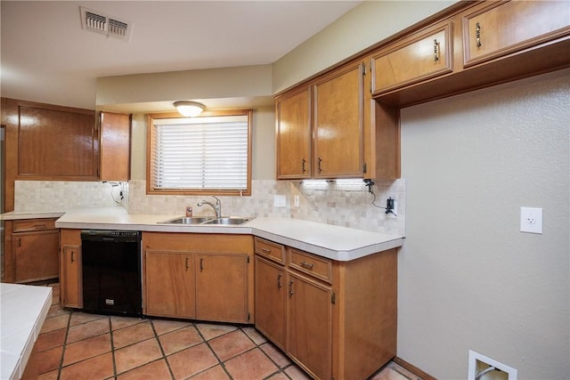 kitchen with tasteful backsplash, sink, black dishwasher, and light tile patterned flooring