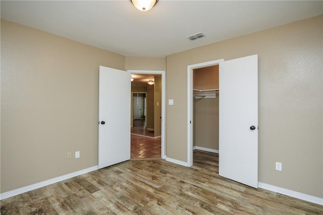 unfurnished bedroom featuring a closet and light wood-type flooring