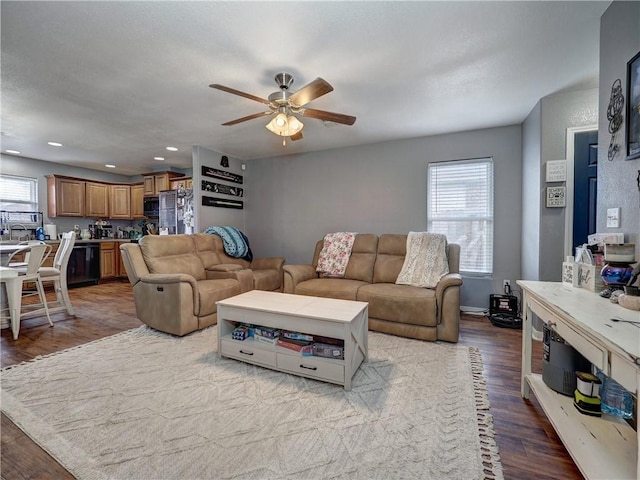 living room featuring wood finished floors, a wealth of natural light, and ceiling fan