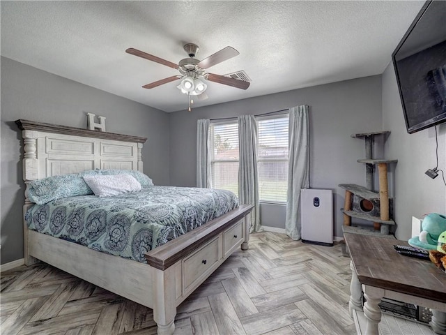 bedroom with visible vents, baseboards, a textured ceiling, and ceiling fan