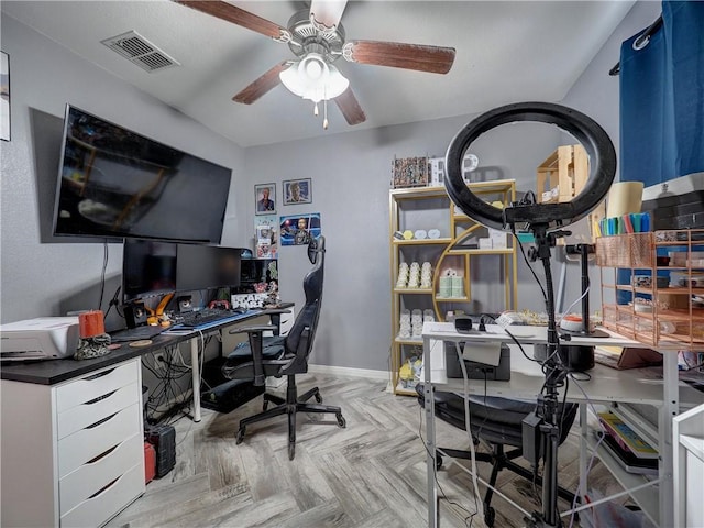 home office featuring baseboards, a ceiling fan, and visible vents