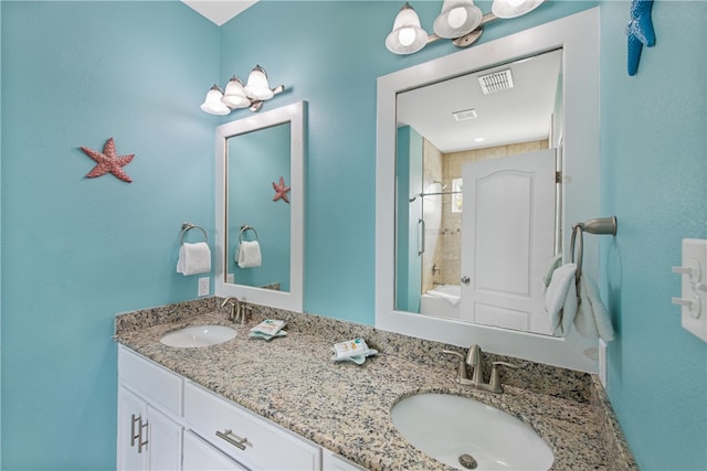 bathroom with vanity and tiled shower / bath