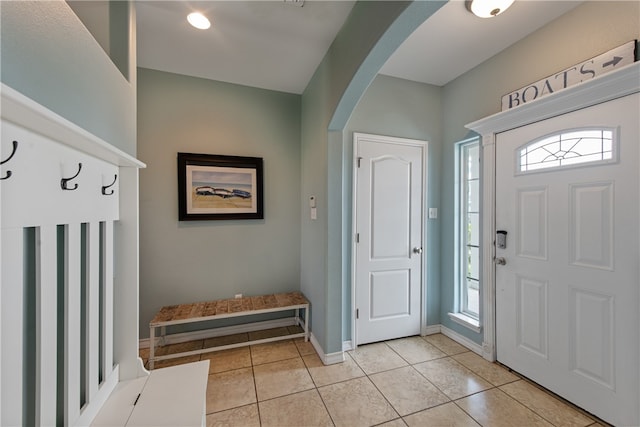 foyer entrance featuring a wealth of natural light and light tile patterned floors