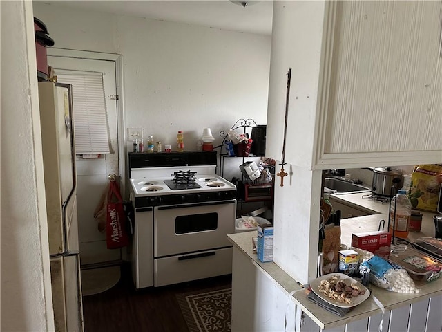 kitchen featuring stainless steel refrigerator and white range oven