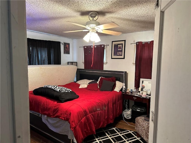 bedroom with ceiling fan and a textured ceiling