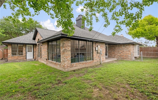 4530 Megal Dr, Corpus Christi, TX 78413 - back of property with a chimney, a shingled roof, brick siding, and a sunroom