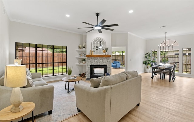 4530 Megal Dr, Corpus Christi, TX 78413 - living room featuring a chandelier, light wood finished floors, recessed lighting, a glass covered fireplace, and ornamental molding