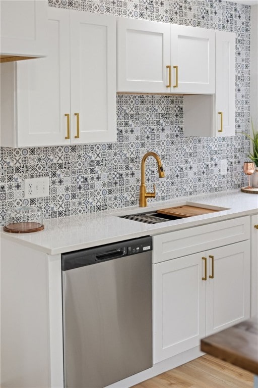 4530 Megal Dr, Corpus Christi, TX 78413 - kitchen featuring stainless steel dishwasher, a sink, light countertops, and decorative backsplash