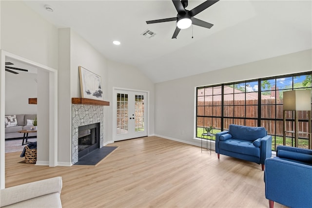 4530 Megal Dr, Corpus Christi, TX 78413 - living area with ceiling fan, a fireplace, light wood-style flooring, baseboards, and high vaulted ceiling