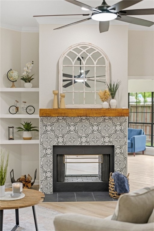 4530 Megal Dr, Corpus Christi, TX 78413 - detailed view of a tile fireplace, ornamental molding, wood finished floors, built in shelves, and ceiling fan