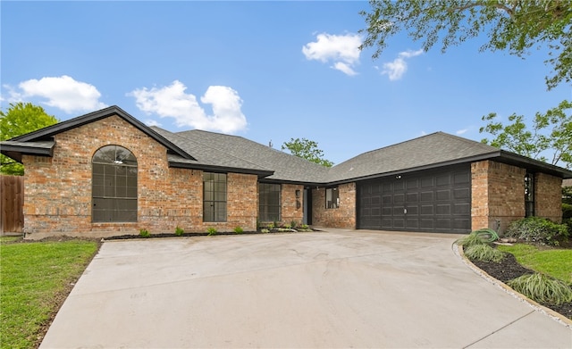 4530 Megal Dr, Corpus Christi, TX 78413 - ranch-style house featuring brick siding, an attached garage, roof with shingles, and driveway
