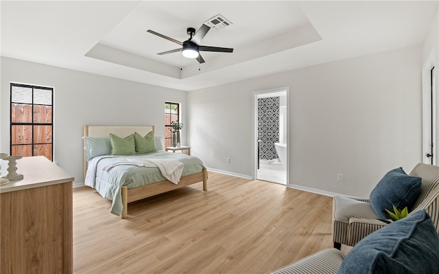 4530 Megal Dr, Corpus Christi, TX 78413 - bedroom with a tray ceiling, light wood-style floors, baseboards, and ceiling fan