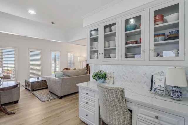 office area featuring light hardwood / wood-style floors and crown molding