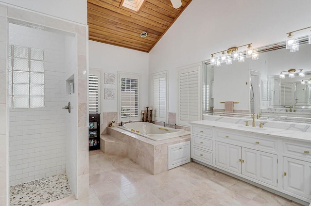 bathroom featuring wooden ceiling, high vaulted ceiling, vanity, a skylight, and independent shower and bath